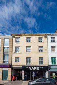 a building on a street with a car parked in front at Market Square Apartments in Huddersfield