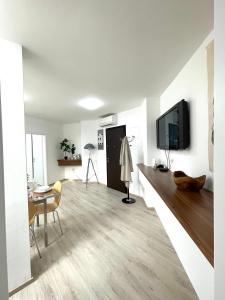 a living room with a television and a dining room at The City Loft in Ljubljana