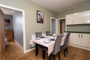 a kitchen and dining room with a table and chairs at Market Square Apartments in Huddersfield