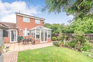 a brick house with a patio and a garden at Wigmore Lodge - FREE Parking & Airport & M1 & Contractor & Leisure in Luton