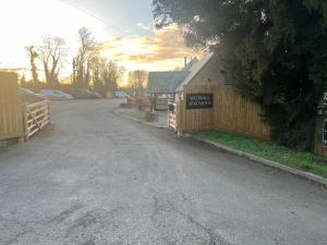 an empty road with a fence and a building at The Rutland in Oakham