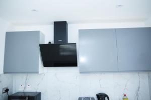 a flat screen tv on the wall of a kitchen at Stunning 1-Bed Apartment in Harrow with parking in Harrow