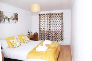 a bedroom with a bed and a window at Lovely 2-Bed Apartment in Harrow in Harrow