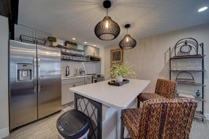 a kitchen with a refrigerator and a table and chairs at Town Square Retreat in Blairsville