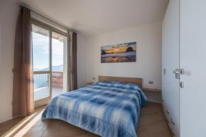 a bedroom with a bed and a large window at Caravaggio in Parzanica