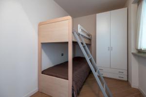 a bunk bed in a small room with a ladder at Caravaggio in Parzanica