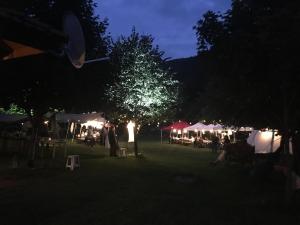 a group of tents and tables in a park at night at Бунгала Дара in Kalofer