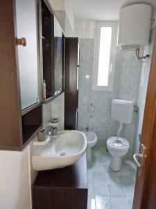 a bathroom with a sink and a toilet at CASA BOUNTY in Trieste +11 photos
