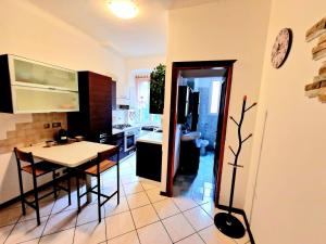 a kitchen with a table and a dining room at CASA BOUNTY in Trieste
