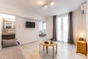 a living room with a couch and a table at Optasia - Naxos Center Cozy House in Naxos Chora