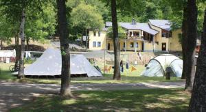 a group of tents in a field with trees at Camping Kautenbach in Kautenbach