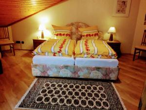 a bedroom with two beds and a rug at Landhaus Christina in Bad Dürrheim