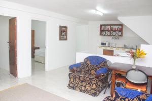 a living room with a chair and a table at Comfort Air B & B in Mount Gay