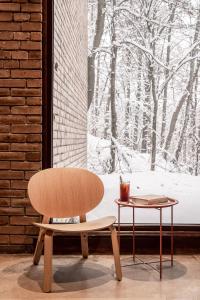 a chair and a table in front of a window at Forest Hotel in Krakow