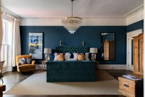 a living room with blue walls and a couch at No38 The Park in Cheltenham