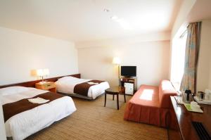 Postel nebo postele na pokoji v ubytování Niigata Toei Hotel