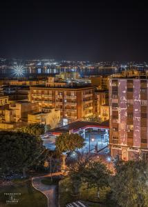a city at night with buildings and lights at Hotel La Conca in Villa San Giovanni