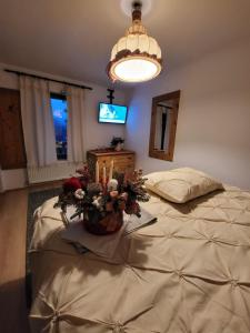 a bedroom with a large bed and a light at Pensiunea Bradet in Broşteni