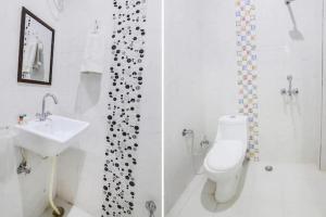 a bathroom with a toilet and a shower and a sink at Corbett Wildlife Homestay in Rāmnagar
