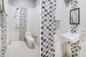 a bathroom with a toilet and a sink at Corbett Wildlife Homestay in Rāmnagar +5 photos
