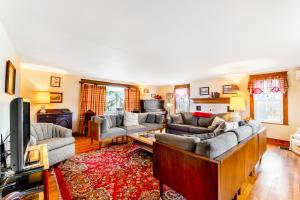 a large living room with couches and a television at Seneca Lake Farmhouse 