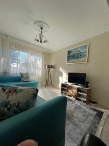 a living room with a blue couch and a television at Taksim house in Istanbul