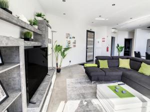 a living room with a couch and a fireplace at Villa Stella by LovelyStay in Arco da Calheta