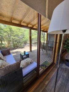 a room with a bed and a large window at Refugios de Montaña Reloncaví - Ruka Lee IV in Nevados de Chillan