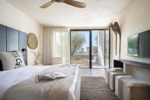 a bedroom with a bed with a book and a tv at Pereh Mountain Resort in Gadot