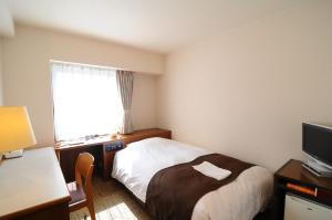 Postel nebo postele na pokoji v ubytování Niigata Toei Hotel