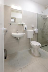 a bathroom with a toilet and a sink at Rijeka Budget Rooms in Rijeka +16 photos