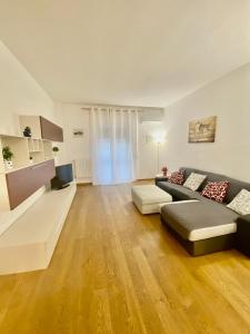 a large living room with a couch and a tv at HomeClass in Bari