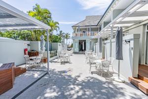 a patio with a bunch of chairs and tables at Beach Wood Boutique Hotel & Resort in Ballito