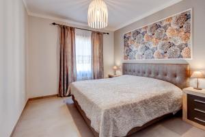 a bedroom with a bed and a large window at Cozy two bedroom apartment in San Blas Golf del Sur Tenerife in San Miguel de Abona