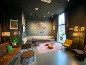 a living room with a couch and a table at Schulz Hotel Berlin Wall at the East Side Gallery in Berlin