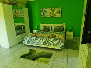 Dormitorio verde con cama y pared verde en Villa do Lago, en Silves