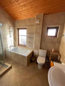 a bathroom with a tub and a toilet and a sink at Villa Katalina in Varna City