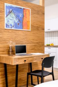a wooden desk with a laptop on it in a kitchen at JAFFA - Authentic Collection - By HOMY in Tel Aviv