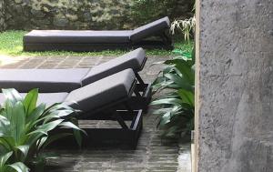 two beds sitting on a brick patio with plants at Saffron Robes Living in Hikkaduwa