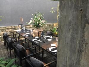 a long table with black chairs and a large chalkboard at Saffron Robes Living in Hikkaduwa
