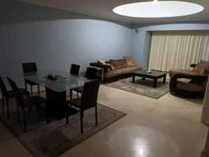 Hurghada Marina في الغردقة: غرفة معيشة مع طاولة وكراسي وأريكة