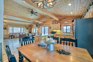a dining room and kitchen in a log cabin at Charming Bedford Cabin with Private Hot Tub! in Thayne