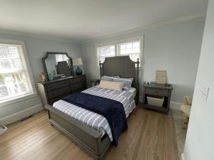um quarto com uma cama com uma cómoda e um espelho em Nubble Beach House- York Beach Oceanfront w/ Amazing Views em York