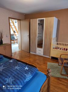 a bedroom with a bed and a room with a crib at Ferienwohnung Grote in Deensen