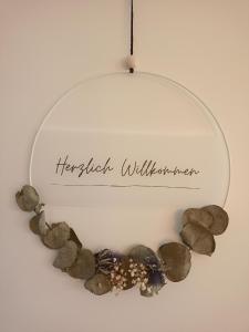 a wreath with rocks and a sign that reads therapist wilderness at Ferienwohnung Mundry 