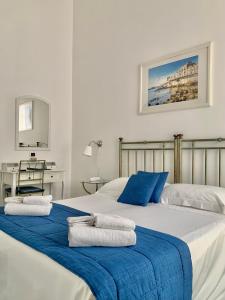 a bedroom with two beds with towels on them at Hotel Posta in Siracusa