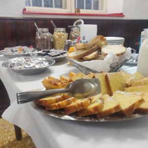 a table topped with a plate of bread and toast at Rifugio La Capanna in Claviere