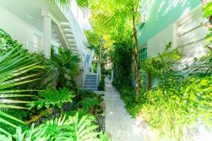 a hallway of a building with trees and plants at PRAIA Hotel Boutique & Apartments Miami Beach in Miami Beach
