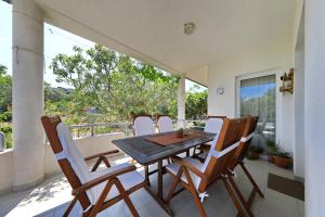 a dining room with a table and chairs on a balcony at Apartment Justina in Murter