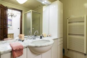 a white bathroom with a sink and a mirror at Caprera Flexyrent NO air conditioning - Seafront in Santa Margherita Ligure +56 photos